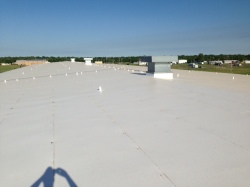 Coryell employee taking image of completed roofing project