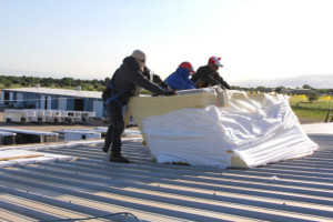 Three Coryell roofers installing a Duro-Last roofing system