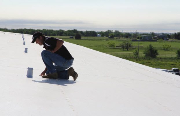 Coreyll Roofing Team Member Inspecting A Commercial Roof.